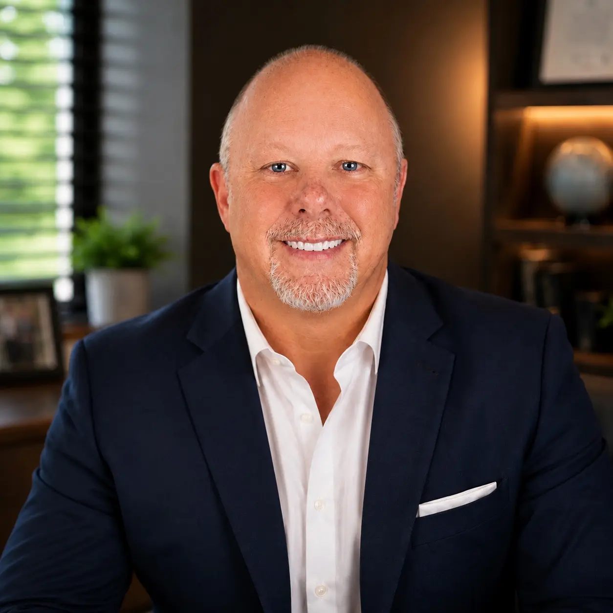 Professional portrait of James Michael Kaufer wearing a navy suit